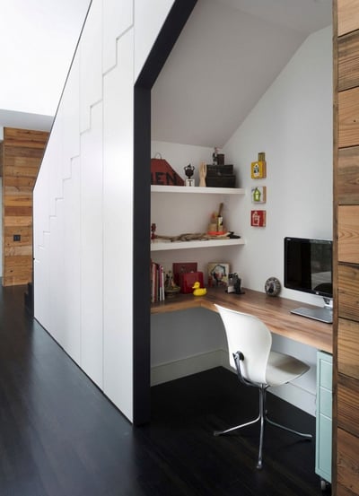 office desk under hallway stairs