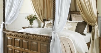Custom drapes and upholstery elevate a bedroom's interiors