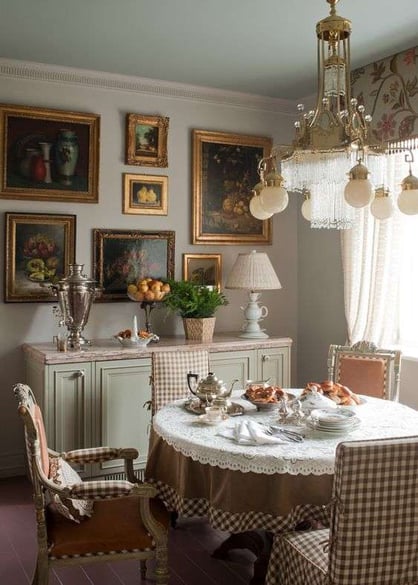 traditional dining room with light greens, brown and pink patterned furniture and artwork 