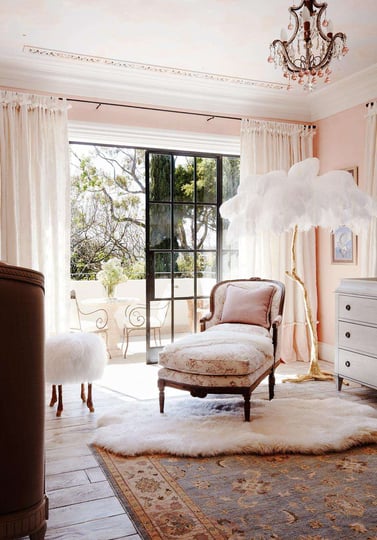 light pink bedroom with balcony, chaise seat and elegant standing lamp with white feather shade 