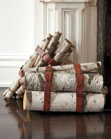 stacks of firewood logs held in bundles using brown leather behs