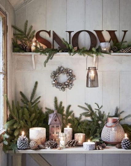 festive christmas mantle place with white ornaments and pine twigs  christmas bedroom inspiration