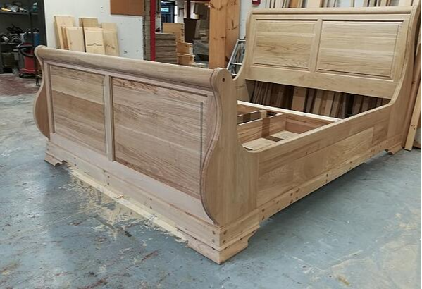 sleigh bed with bespoke additions in workshop